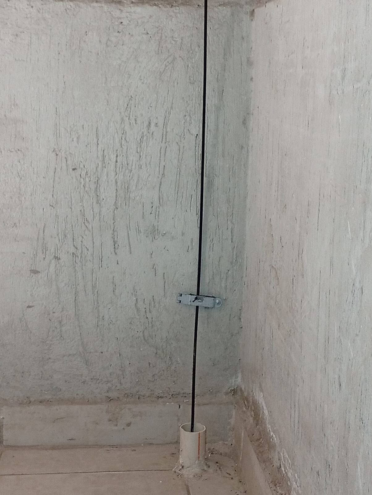 Vertical cable secured to wall