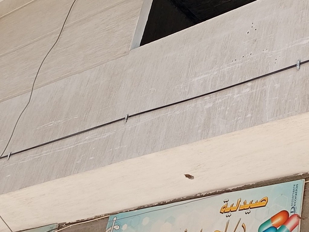 Clipped FTTH cable along building facade
