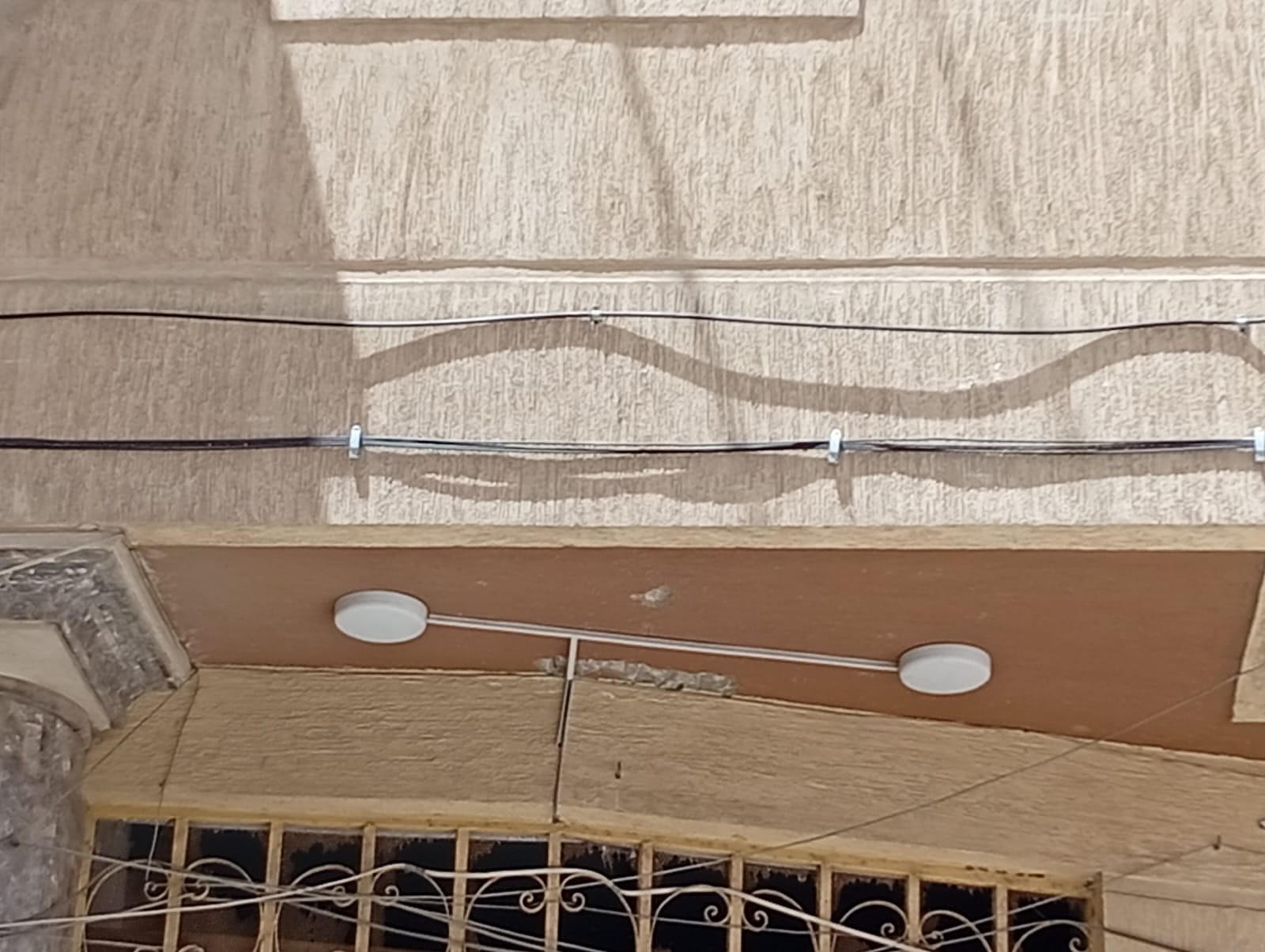 Fiber cable secured below balcony