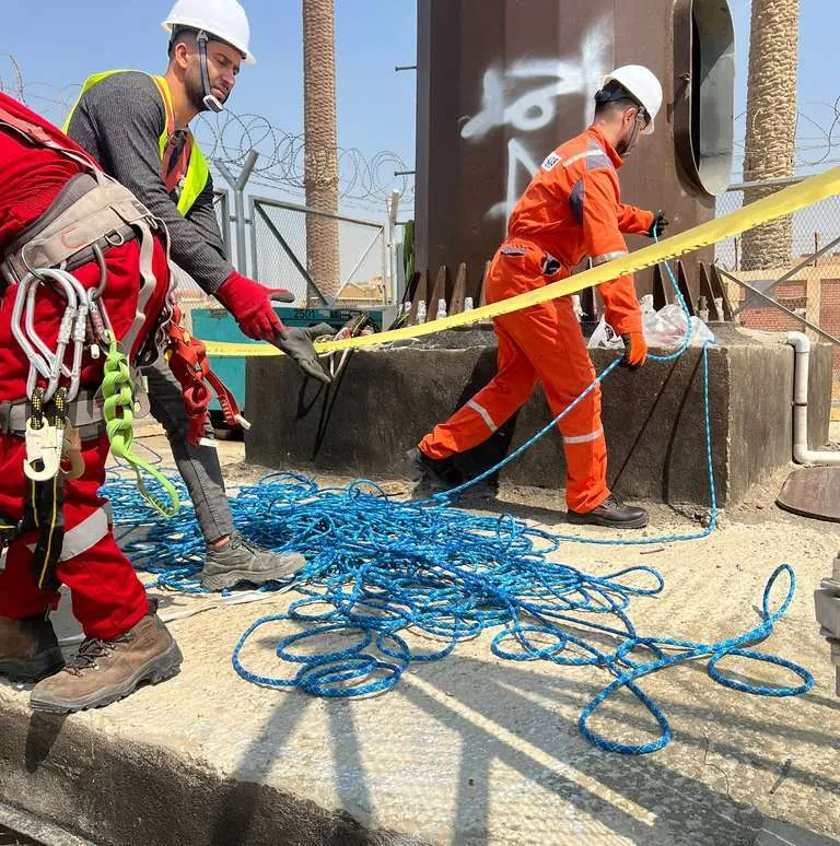EGYTEL rope-access team preparing equipment during a safety trial